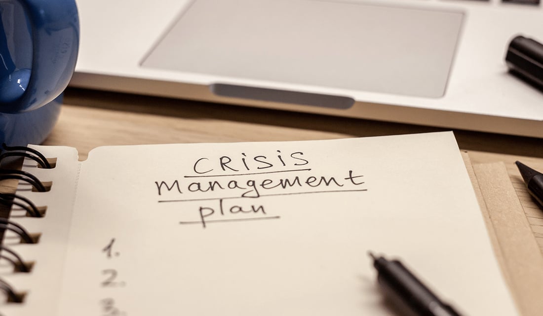 zoomed in notepad of text that says crisis management plan