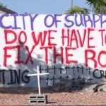 ‘Do we have to die? Fix the road’: Phoenix family turns to drastic measures to get help after 18 cars have crashed into their home — they say it’s just a matter of time before someone dies
