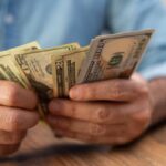 I just inherited $10,000 — but all I’m hearing these days is the US is headed for a recession. Should I use the cash to pay off my $9,000 credit card debt or keep it for my emergency fund?